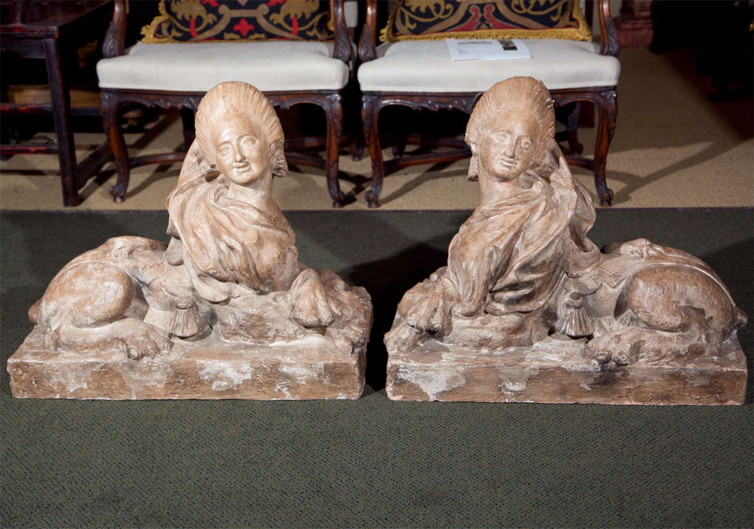 A pair of large French terra cotta sphinxes in the likeness of Madame du Pompadour.