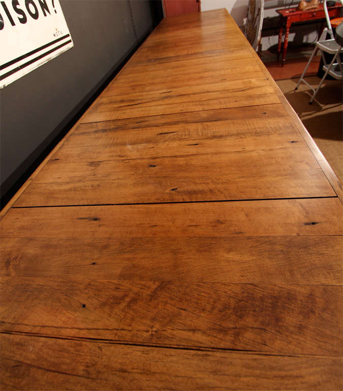 The top on this beautiful & functional piece is curly maple. The lower shelf and legs are galvanized with adjustable feet.  The dark area must have been heavily used and has been throughly cleaned, sanded and sealed for cleanliness.