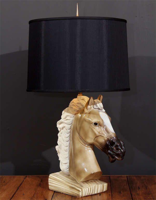 A ceramic Palomino horse head with a flowing mane make up the base  for this vintage lamp;  we've topped it with a chic gold-lined black shade and a cast brass pointed finial. 

This has been professionally re-wired and the shade is new.