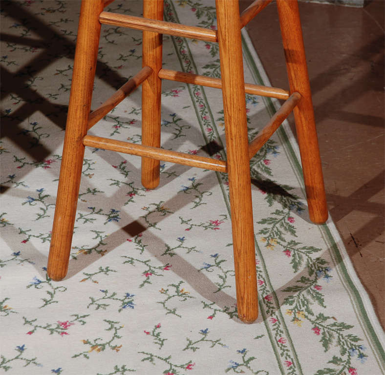 Set of three 1950 Arthur Umanoff walnut barstools. These stools are classics--they are a timeless style overlapping into many styles from mid century to mountain cabin. They are in perfect condition and very comfortable. Have not seen these chairs