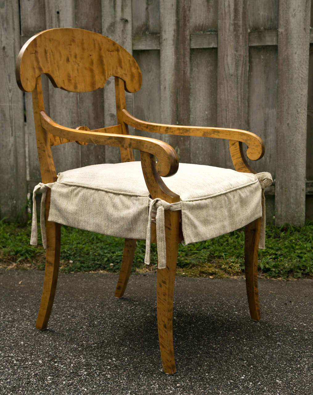 A set of four Biedermeier chairs, two with arms. Solid tiger maple construction and lovely scrolled design.