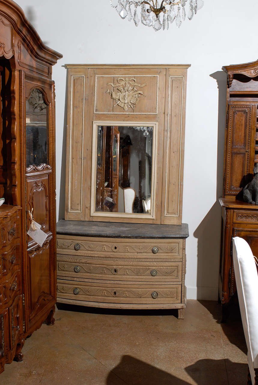 A French Louis XVI style natural wood trumeau mirror with musical trophy and original glass from the mid-19th century. This French wooden trumeau mirror features a simple, linear Silhouette marked by two paint-accented pilasters, reminiscent of the