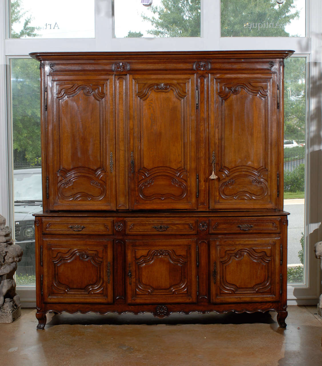 A French period Louis XV mid-18th century carved wood enfilade à deux-corps from the Lorraine region. This French cabinet was born in the Eastern Lorraine region of France in the later years of the reign of King Louis XV. Featuring a large molded