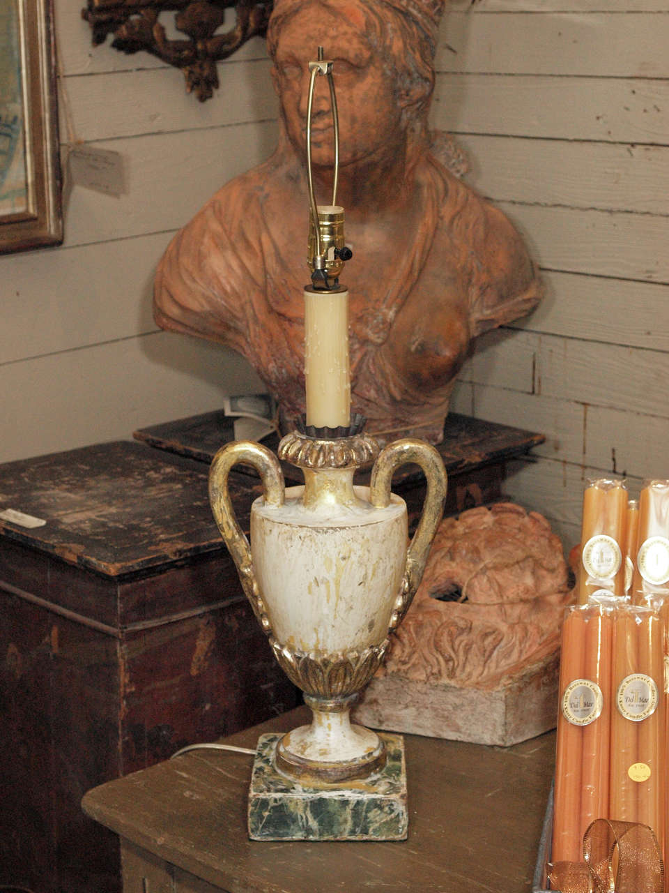 Urn shape painted wood lamp with gilded handles on a faux marble base.