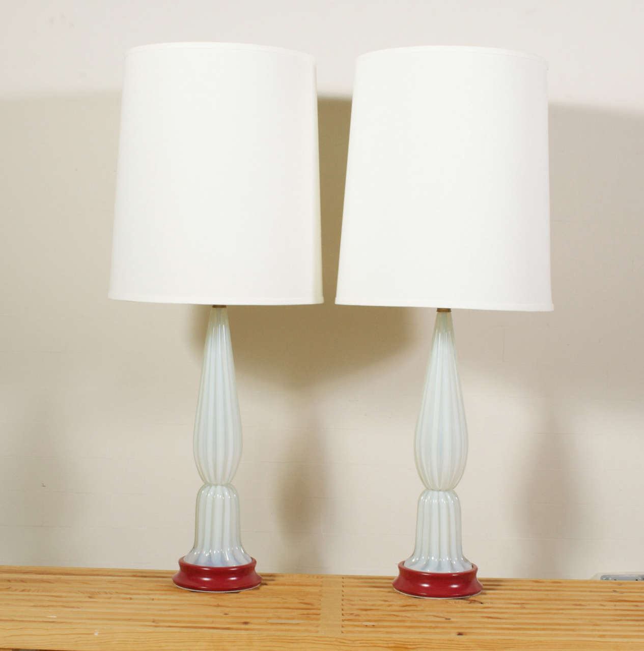 A nice pair of translucent opalescent lamps, that look to be light cased also. No markings, but very Murano, Italian. They stand on painted red bases, and end with a Brass neck. Shades not included, height measurement to top of harp.