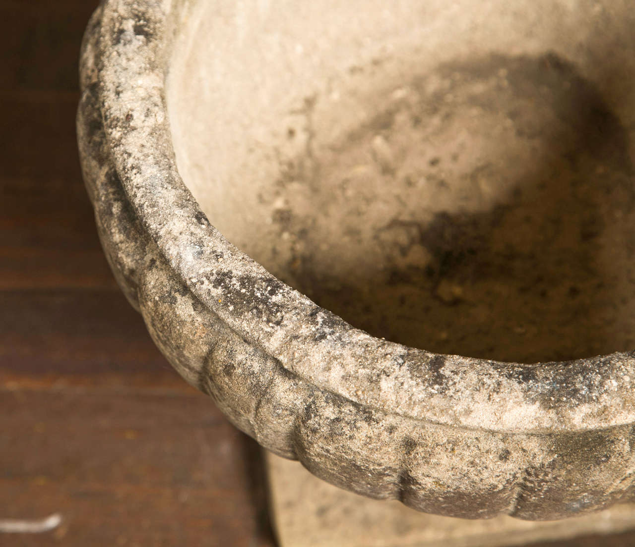 Beautiful set of four cast stone urns from England. Base is 8.5