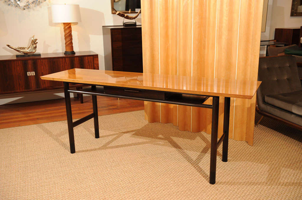 Elegant Edward Wormley design console table for Dunbar. Figured walnut top on mahogany turned base and leather wrapped feet. Excellent original condition, labeled.