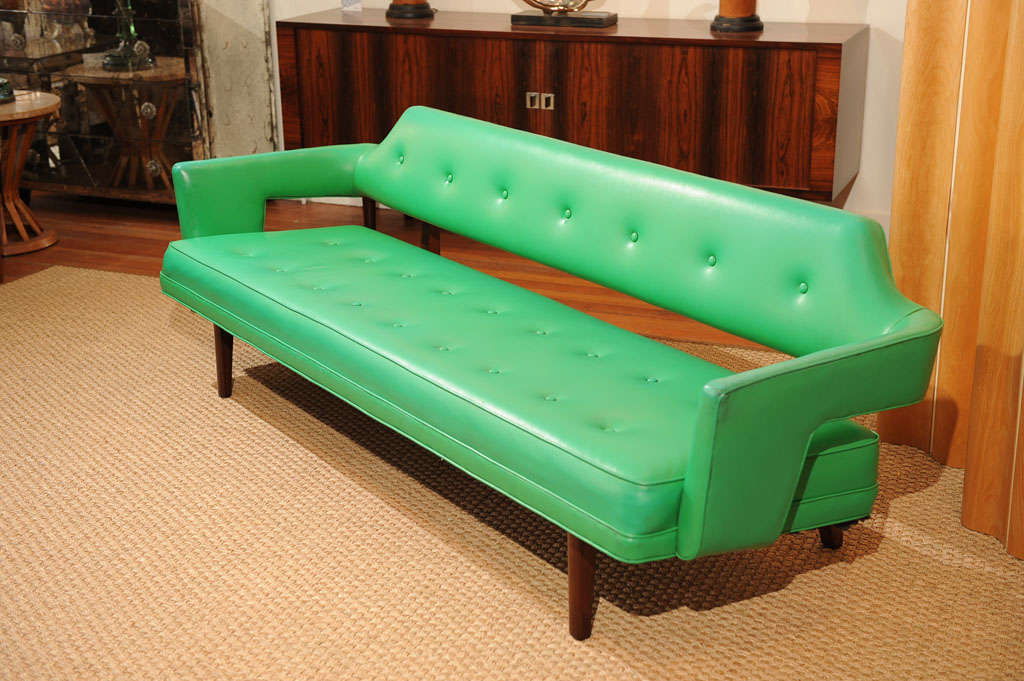 Stunning Edward Wormley design sofa for Dunbar, refinished mahogany base and original electric green leatherette upholstery in excellent condition. Labeled.