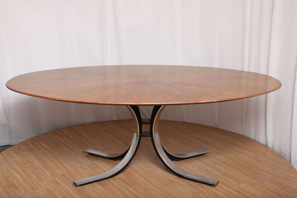 A gorgeous dining table by Borsani for Stow Davis. The top is walnut with a sunburst patterned veneer, atop Borsani's signature painted iron and chromed metal base. The table comfortably seats six, a perfect size and shape that nicely balances