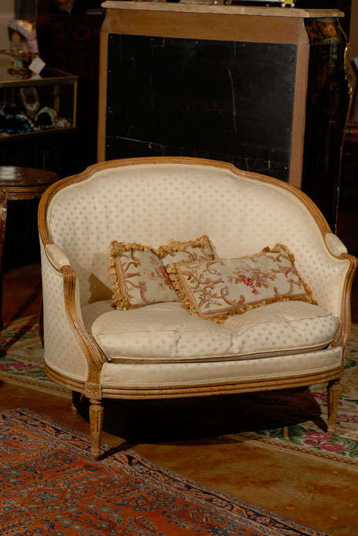 Small French settee with rounded back and sides. Beautifully carved bleached walnut frame.