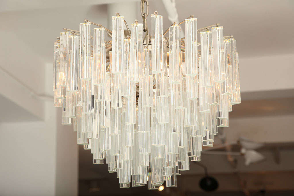 Venini chandelier for Camer made with clear Murano glass bar prisms hanging from a steel frame with 4 lights. There's only been one owner of the chandelier and it's signed with the original label.

