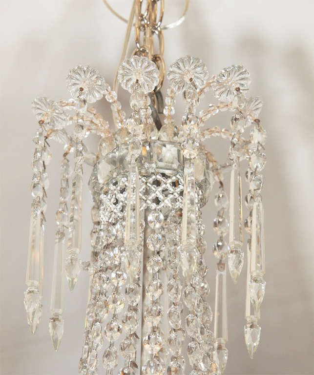 Exceptional small french crystal empire style chandelier. all origianl crystals on a silver painted frame. Great proportion.