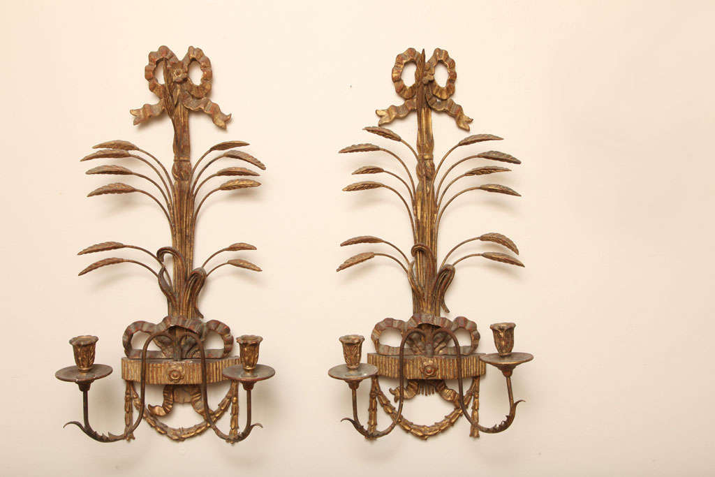 Impressive pair of hand carved wood and gilded metal sconces by Palladio.