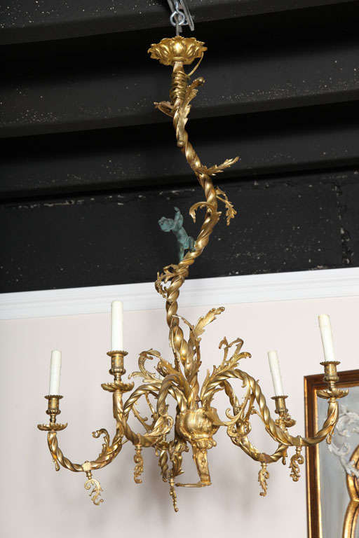 Elegantly whimsical Dore bronze five-arm chandelier with a single putti looking up towards the sky.  Originally a late 19th century gas fixture which was later converted to electric.