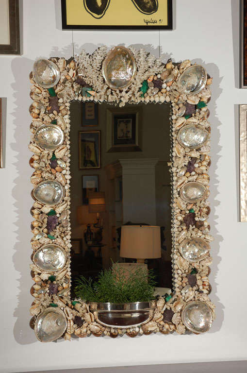 An elaborate hand made sea shell and coral encrusted wall mirror with amethyst and malachite elements designed by Anthony Redmile. Mirror also features a silver plated planter for creating beautiful arrangements. This is the 2nd time we have had the