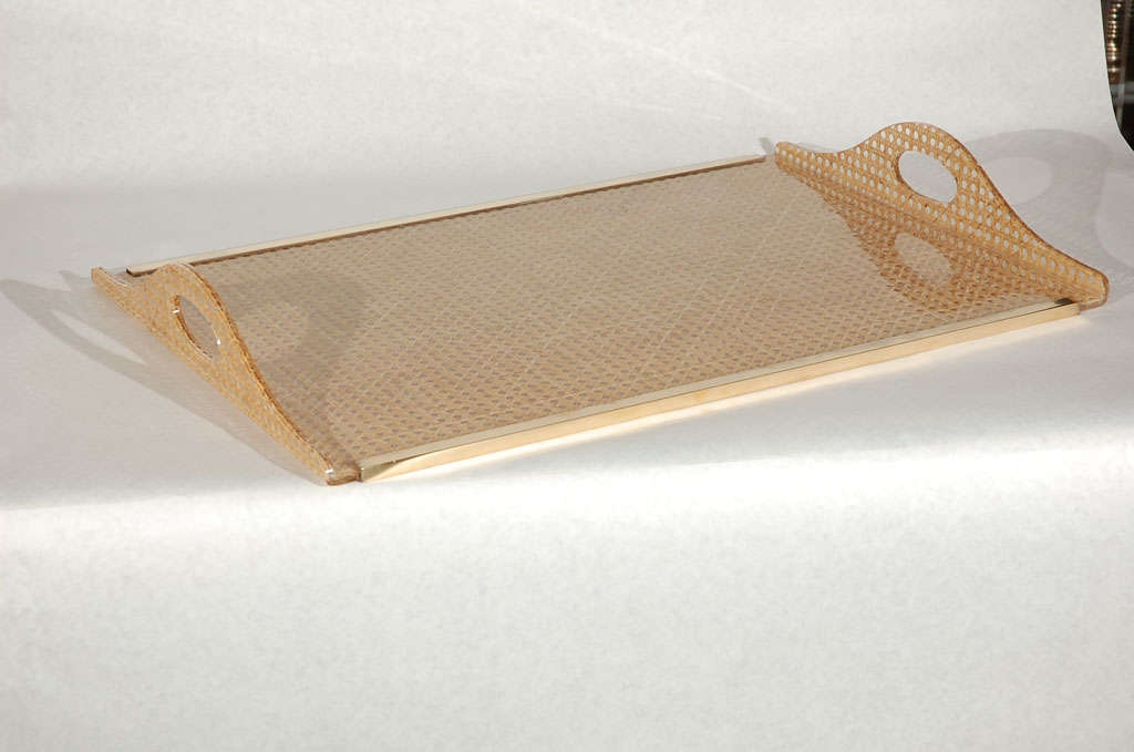 Large lucite serving tray cleverly encasing woven cane with brass trim.