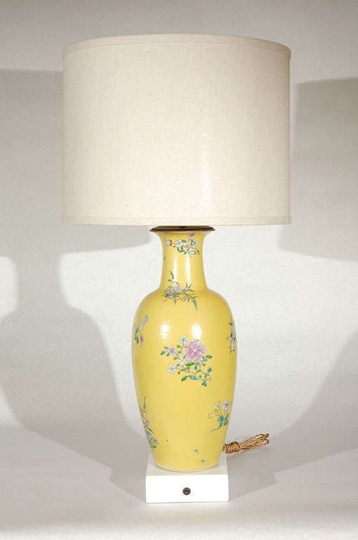 Beautiful Haines table lamp from the Bel Air Estate of F. Hugh and Mary Herbert.  Using a flower decorated yellow glazed urn, the urn has been placed on a lacquered base.  Fitted with brass fittings, the linen shade is new.