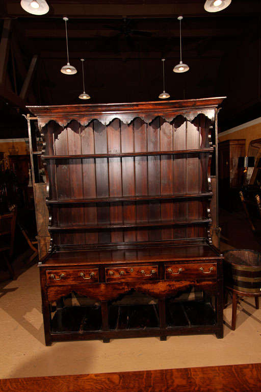 Welsh Dresser With Plate Rack<br />
<br />
This early English cupboard has three bowed shelves for the traditional plate rack display. There are several wonderful iron, hand-forged hooks on the top of the plate rack for utensils.<br />
<br