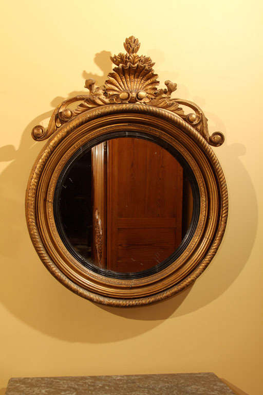 Italian Gilt Regency Style Mirror

This is an Italian mirror in the English neoclassical style. Typically you see this type of mirror as either Regency(English) or Federal (American). 

Usually they would have a convex mirror but this mirror is