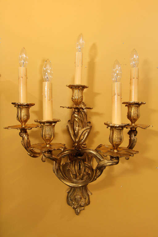 French Louis XV Style Bronze Sconces

This is a pair of five arm bronze sconces with candelabra lights.  

This a wonderful pair due to their large size and their symmetrical design.

Rewired for US specifications.