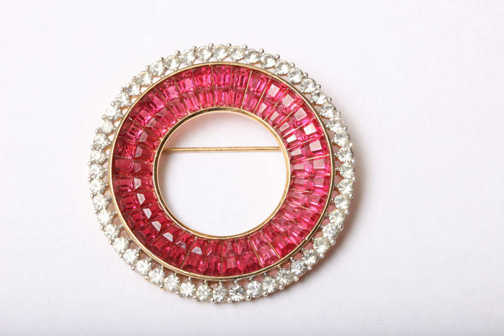 This signed Trifari pin resembles in true form, the look of real rubies and diamonds. 
Classic and elegant. 
The outer rim is clear rhinestone, and the two inner bands are ruby pink rhinestone. 
This pin is part of the invisible set... 
This is