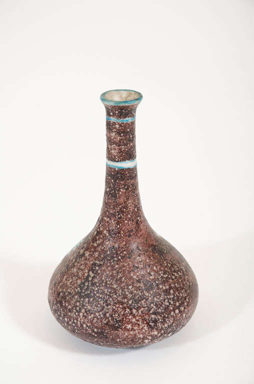 A ceramic bud vase decorated with a whimsical white creature with aqua highlights on a brown mottled ground. Signed Italy to the base.  After Guido Gambone. Italian, circa 1950.