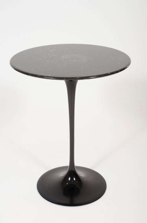 An Eero Saarinen designed occasional table comprising a round black Italian marble top with beveled edge on a black cast metal pedestal base. Mod. no. 160. With Knoll paper label to underside. American, circa 1960.