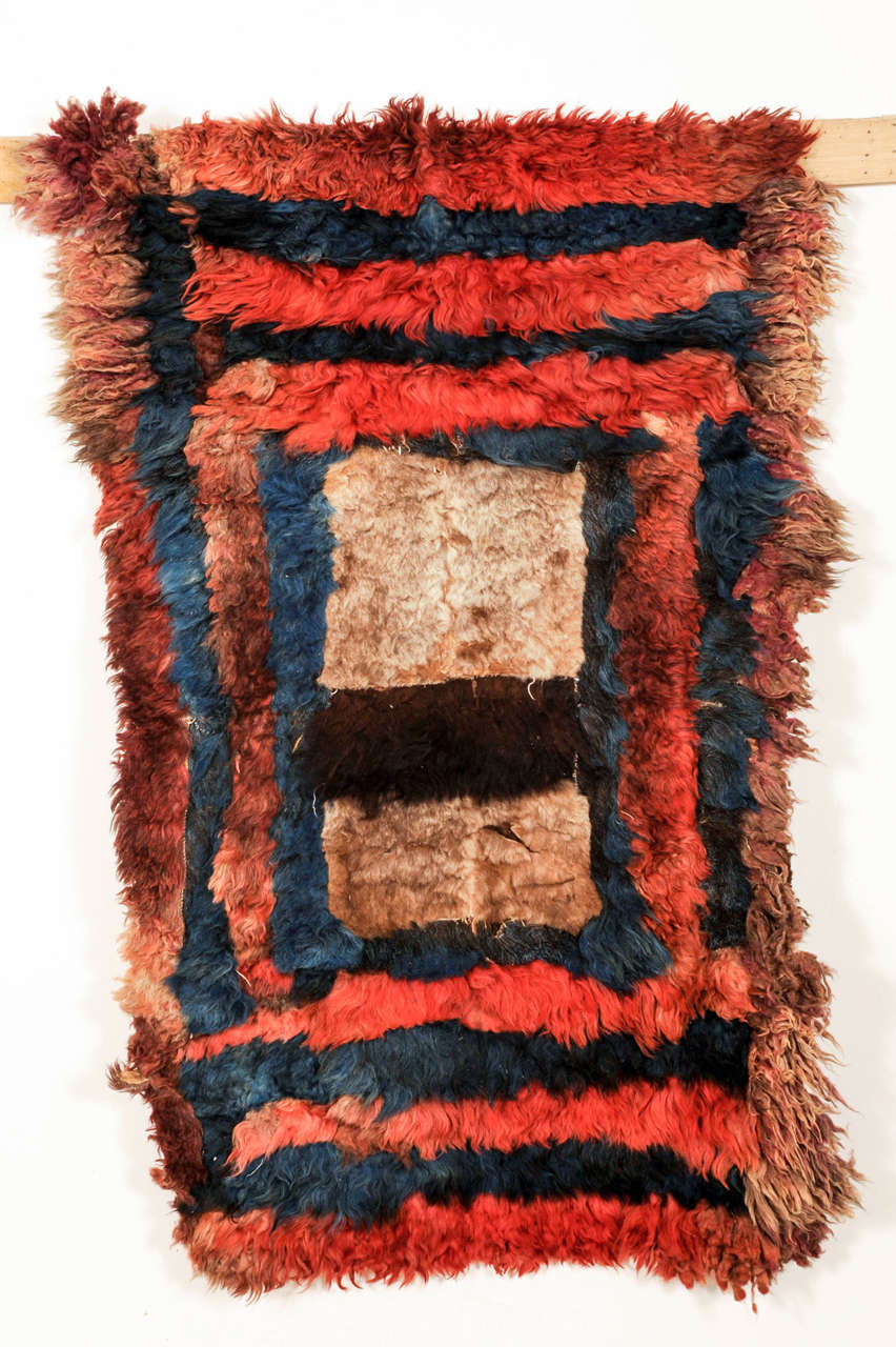 This is a rare example of a 'postak', used by the Kirghiz people inhabiting the Pamir mountains, made up of strips of animal fur hand-stitched together to form a pattern. It represents one of the earliest forms of floor covering known to mankind, as