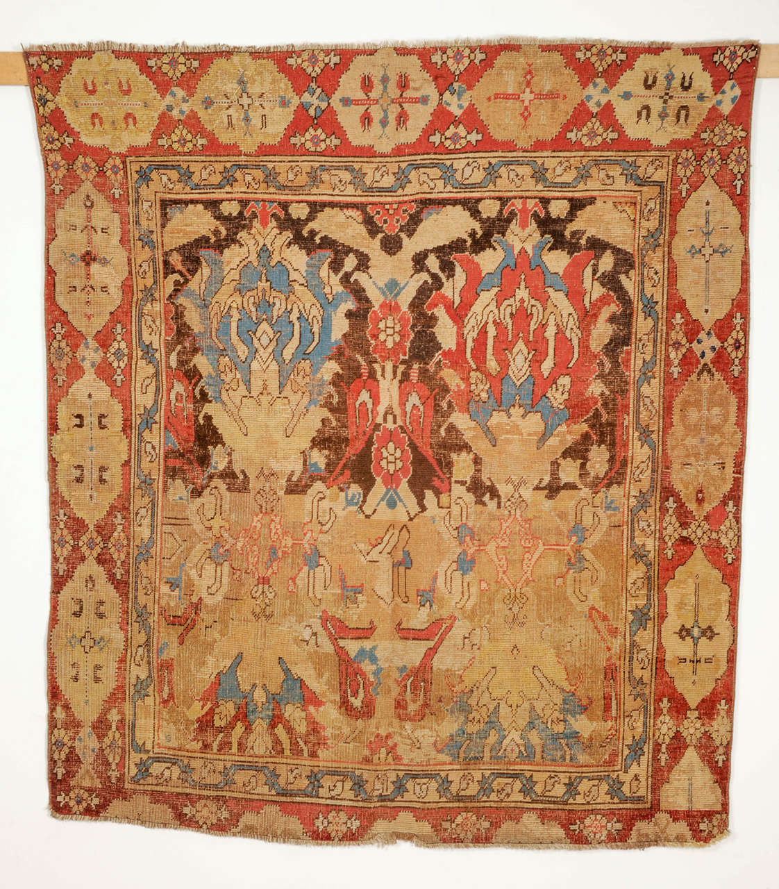 A rare and antique so-called 'Smyrna' carpet, distinguished by an allover pattern consisting of four oversize palmettes arranged in mirror image, framed by an oblong cartouche border typical of 17th century 'Transylvanian' Ottoman carpets. Carpets