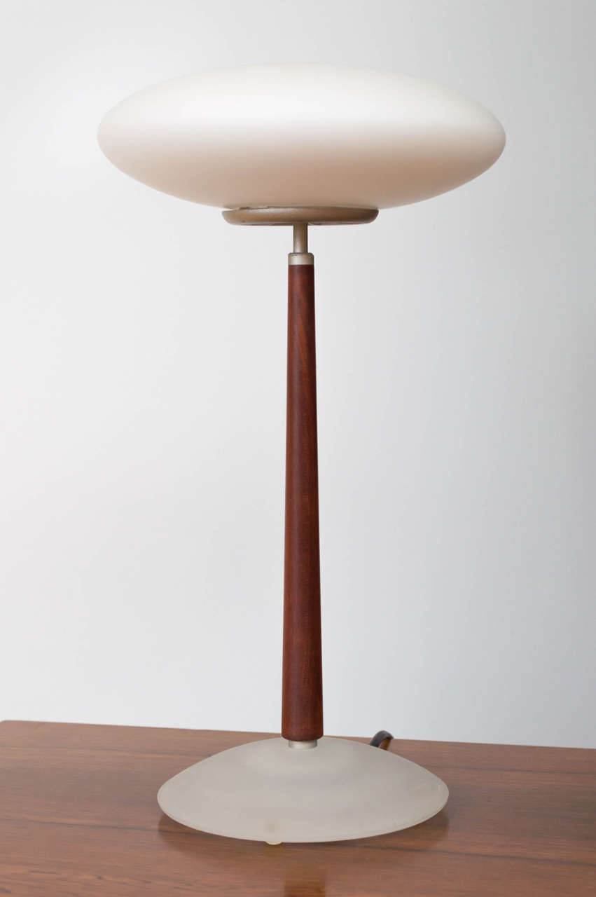 Version T1. A table lamp with blasted glass shade and base and a stained cherrywood stem by one of the major founders of the Memphis movement. 35 watt bulb.