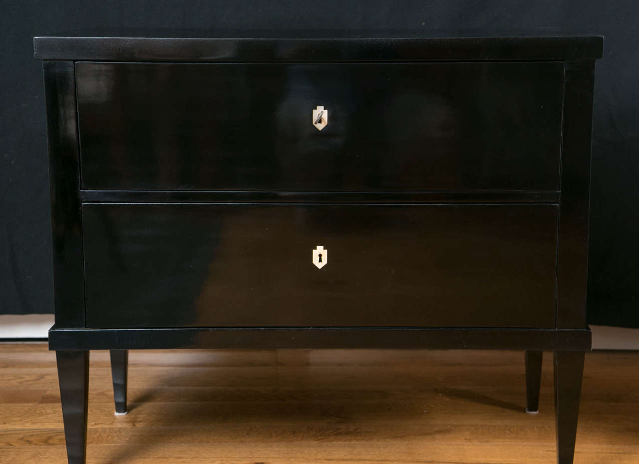 Fabulous pair of Biedermeier style two drawer chests on straight tapered legs with bone inlayed keyholes, first half of the 20th century, recently re-lacquered