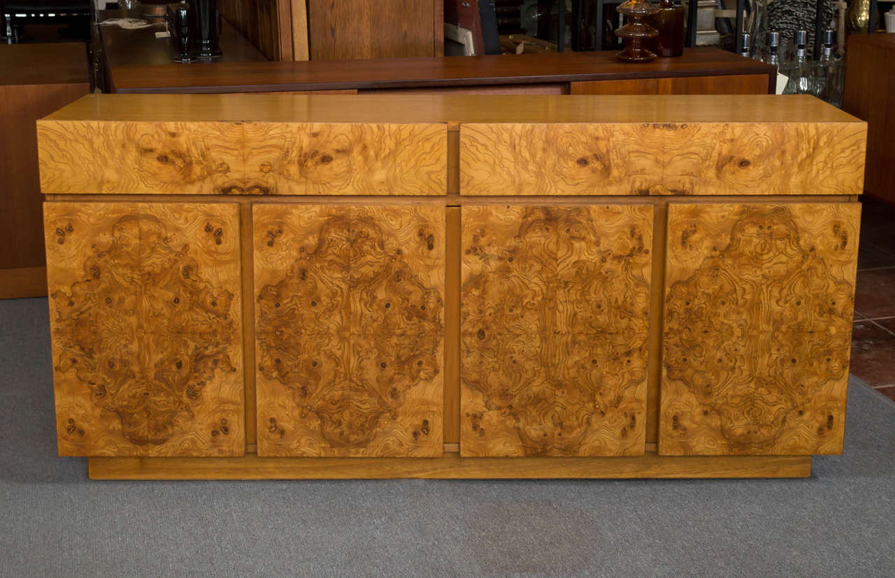 Lane Burl Olive wood credenza, in the style of Milo Baughman's designs. Two drawers, below four doors with shelves behind. Would work nicely with your flat screen on top, or a super deluxe bar.
