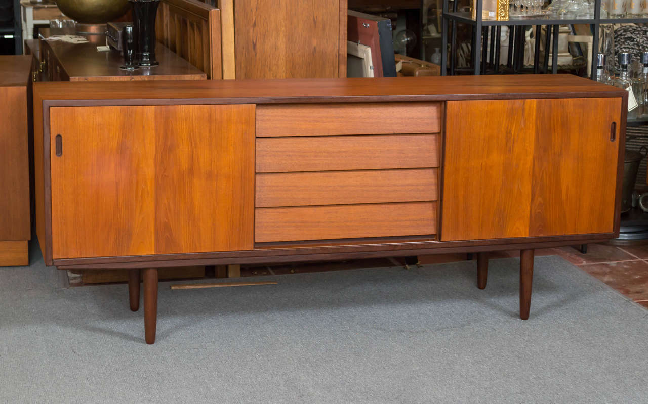 Nice size Danish modern style credenza, Hugo Troeds Sweden. Four drawers in the middle with sliding doors at both ends with one shelf each (not adjustable).