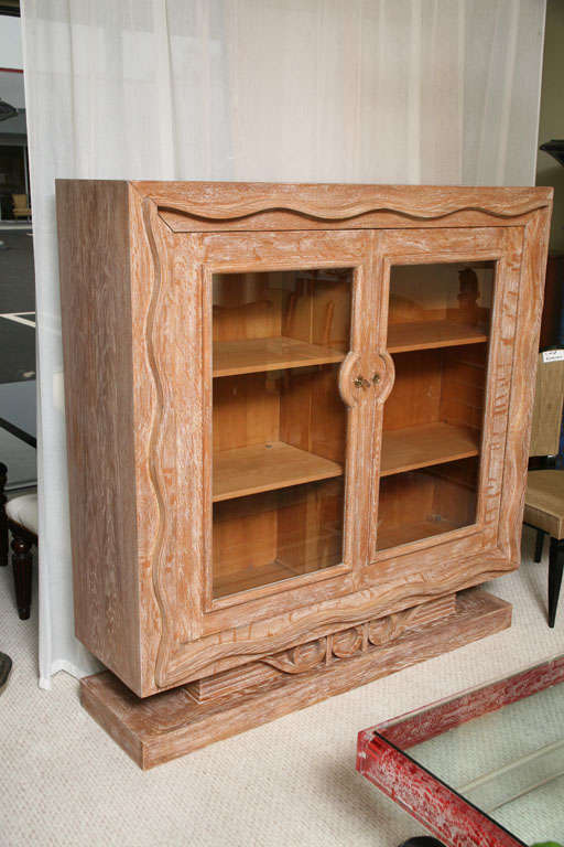 Beautiful, large cupboard/cabinet/bookcase from France. The design is in the style of of Royere. The wood is a beautiful oak cerused. There are four shelves that can be adjusted and more can be added.