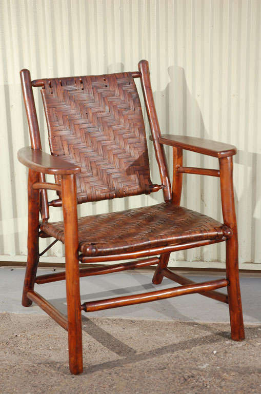 1930'S SIDE CHAIR WITH ADRONDACK ARMS.ORIGINAL SURFACE AND WOVEN SEAT AND BACK.THIS SIGNED OLD HICKORY CHAIR HAS THE ORIGINAL STAMP MARK FROM THE FACTORY UNDER THE RIGHT ARM OF THE CHAIR.