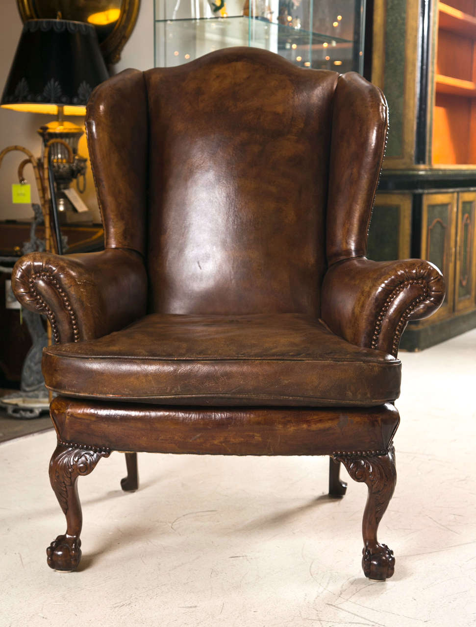 Late 19th C leather wingback chair with ball and claw feet