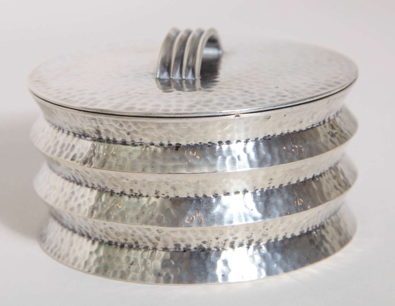 Martele silver box with indented circumferential design with semi-circular handle. 
7.35 ozs.

Czechoslovakian silver mark: triangle with cross over three hills and five indicating 800 silver (mark was used from 1929-1042)/ maker's mark MV.