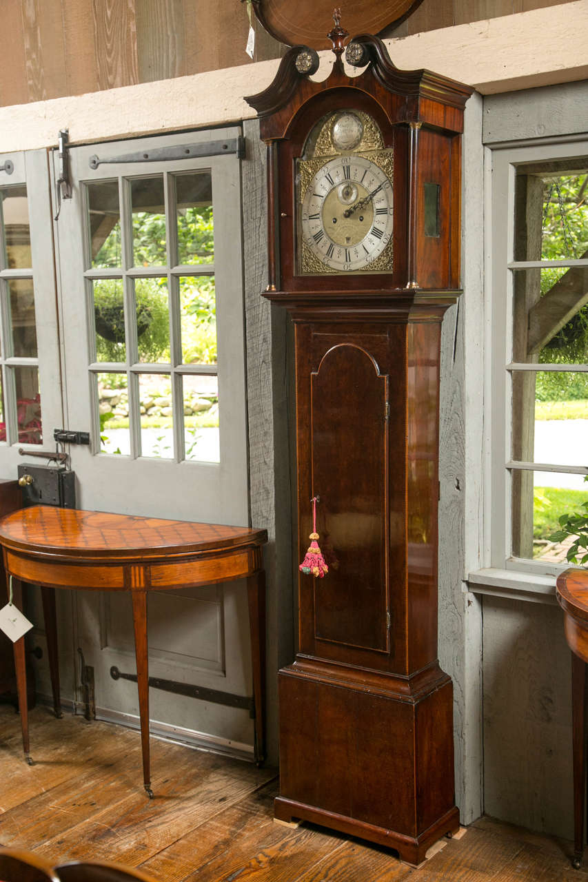 If there were a handbook describing the proper proportions for an English tall case clock, it would not be a shock to find this one in there. In richly toned mahogany with just the right amount of boxwood stringing, this clock strikes an elegant