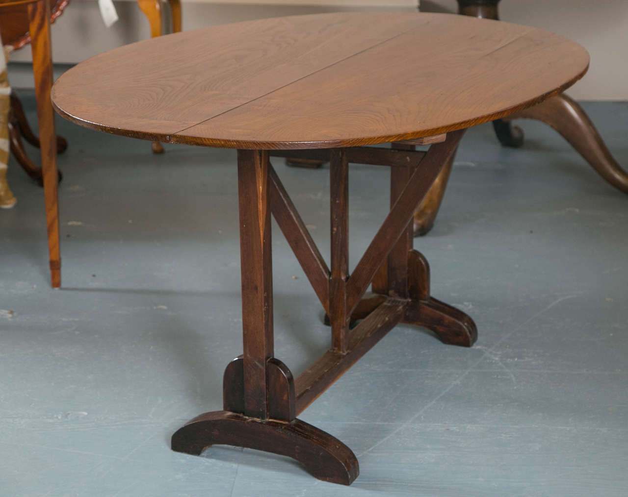 With its tilting, two board elm top and gentle elliptical shape, this table is just the right size and appearance to take outside for some libation enjoyment. Or it could be repurposed to duty in a breakfast nook. The possibilities are not endless,
