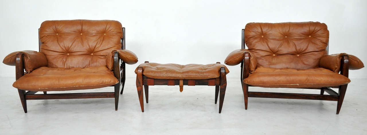 Jacaranda rosewood pair of chairs with ottoman by Jean Gillon. Made in Brazil circa 1960s. Original tan leather upholster.