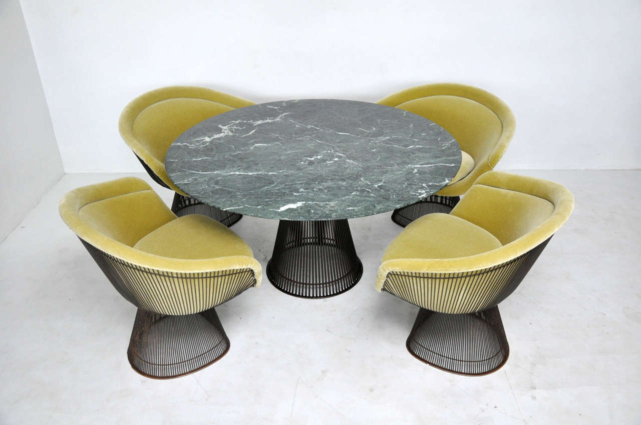 Bronze dining set by Warren Platner. Set of four bronze frame chairs newly upholstered in plush mohair. Bronze frame dining table with green marble top, 48
