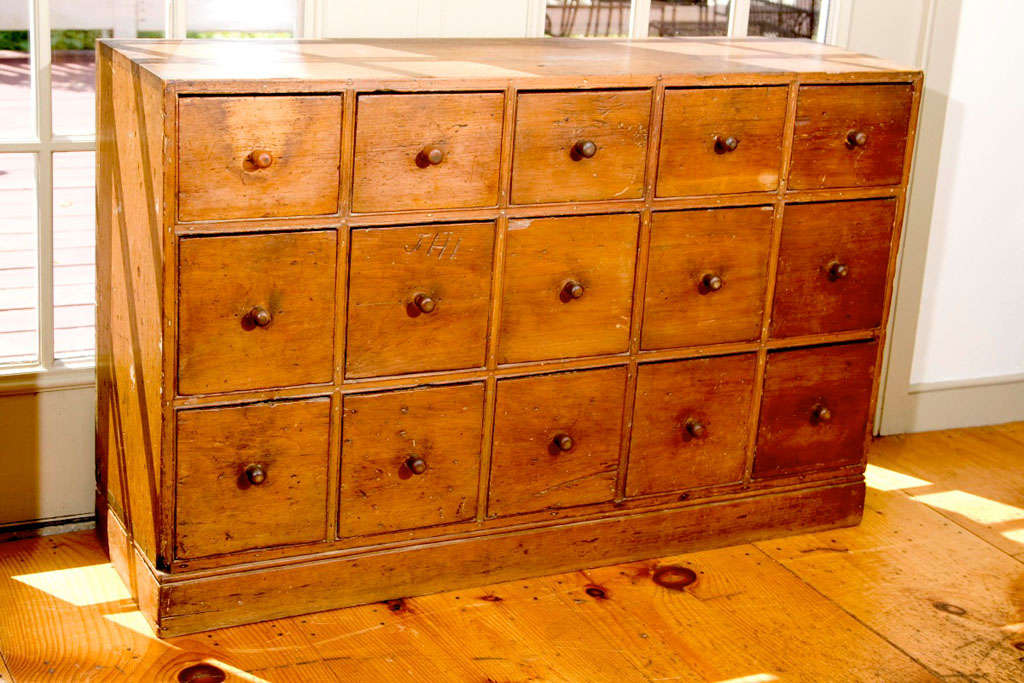 A New England pine Apothecary Chest with 15 drawers, dovetailed case construction and original turned knobs. Originally made as a wooden medicine chest for a Druggist Shop. Retaining a warm mellow patina with excellent wear patterns. Set on late