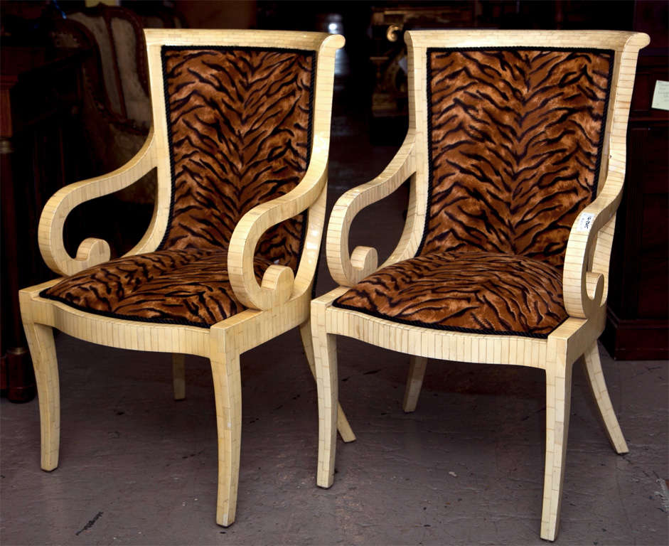 Pair of intriging armchairs, possible third quarter of 20th century, tessellated frame with tiger-print upholstery, scrolled arms.