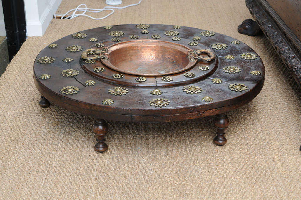 Walnut base decorated with brass stars and medallions. Copper bowl with handles
