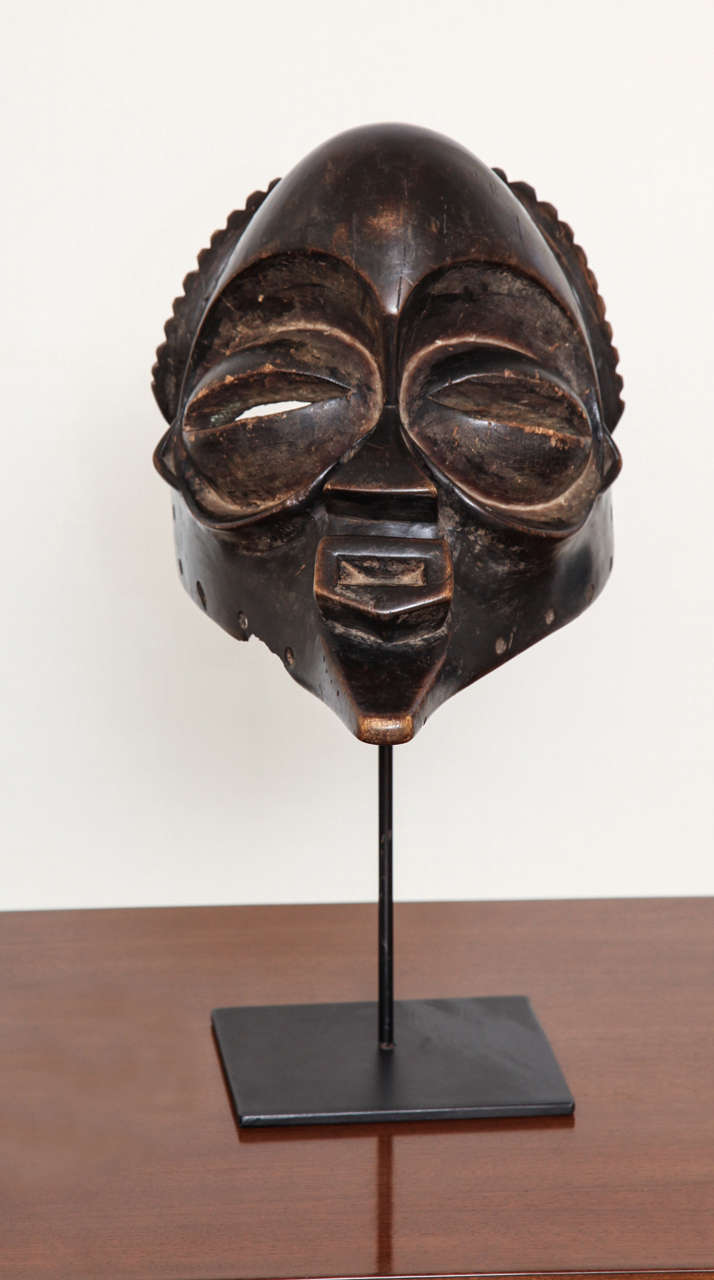 Carved Songye harvest mask mounted on an iron stand, Zaire c. 19th Century