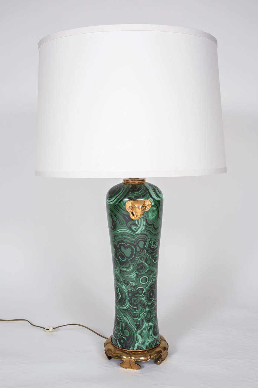 Pair of faux malachite Hollywood Regency table lamps by The Marbro Lamp Company.  Gold elephant accents.  Gold base and finial. New drum shade in Ivory Honan Silk.  Manufactured c. 1960's. Los Angeles, California.  Lamp: 34 3/4