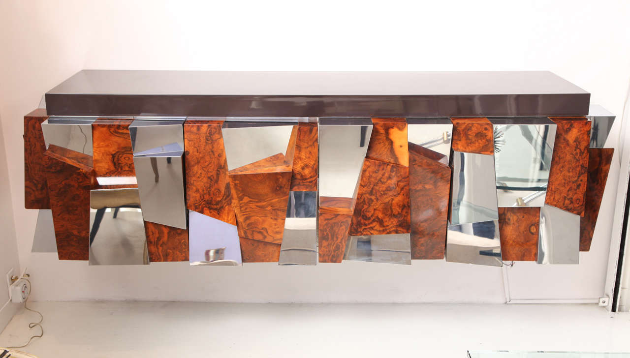 PAUL EVANS (1931-1987)
Wall-mounted console with faceted doors in burlwood and chrome. Top of chocolate brown lacquer.
Two hinged doors open to reveal shelves.
Executed by Directional.
American, c. 1970