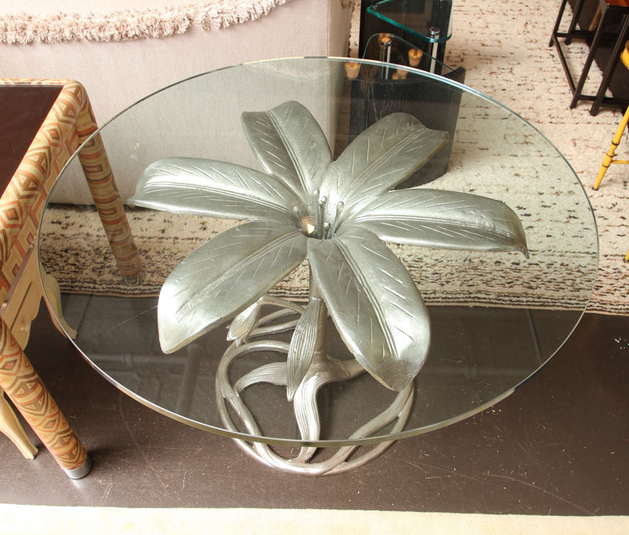 Arthur Court 
Glass top table with a sculptural base in the form of a lily.
Made from cast aluminum.
American, circa 1970.