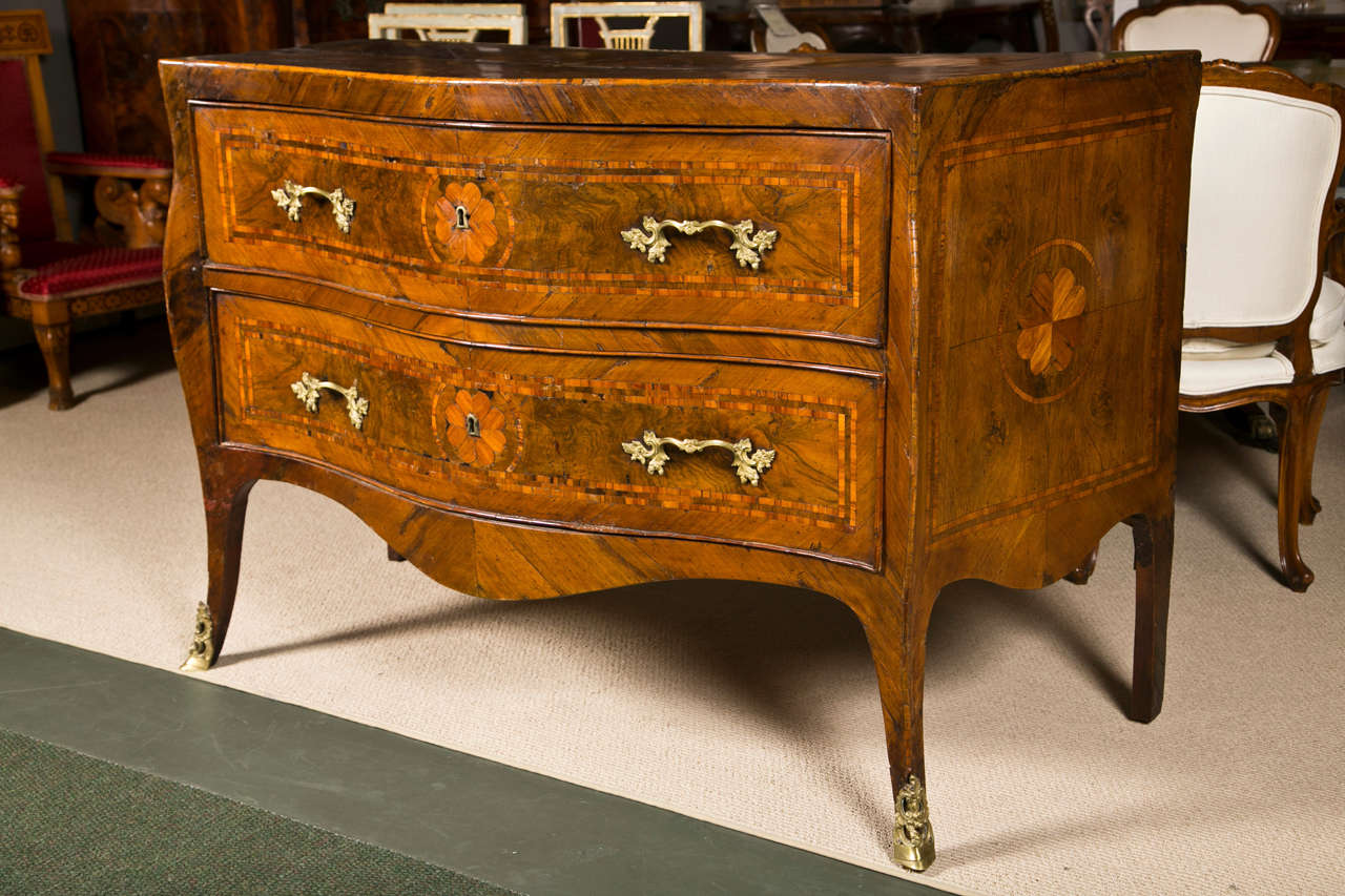 An 18th century Italian Rococo gilt bronze-mounted walnut and fruitwood inlaid chest of drawers, commode, Naples, circa 1760.