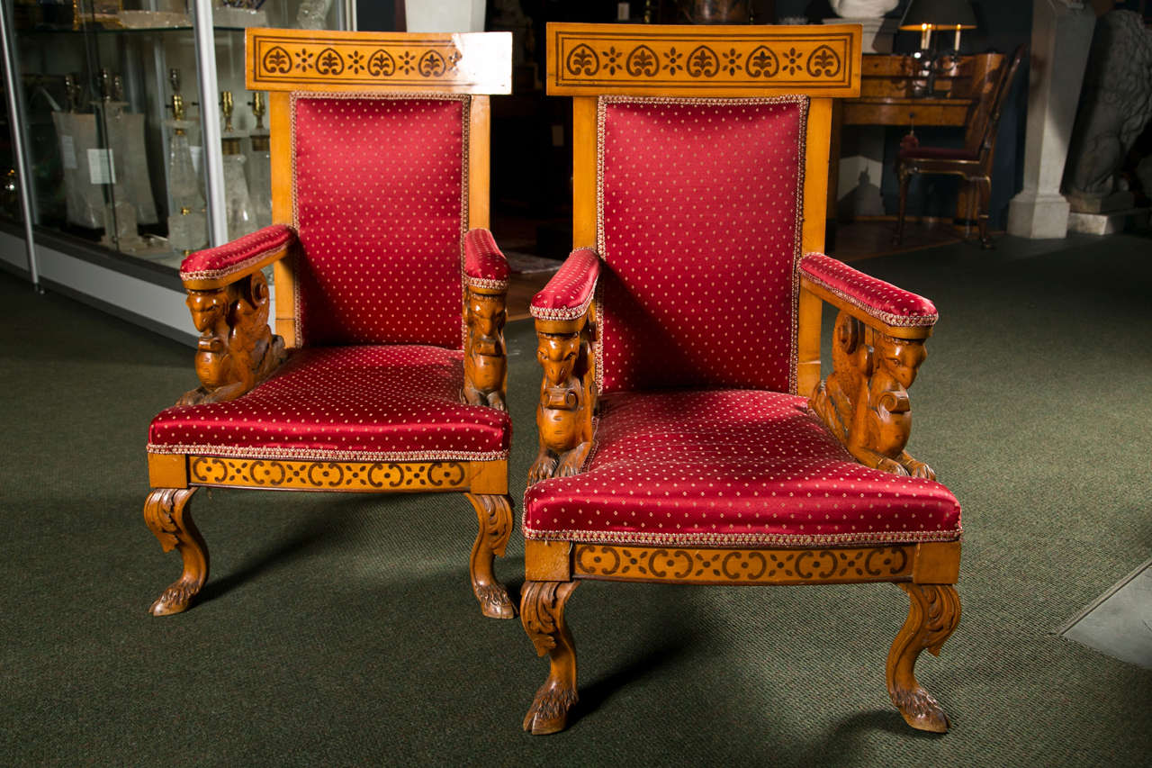 A pair of early 19th century Italian Charles X inlaid and carved bedroom armchairs, circa 1825.